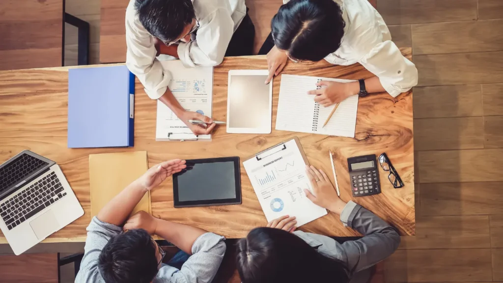 A team of professionals collaborating, illustrating how to hire SEO outsourcing services by ensuring the right team and approach for your business.