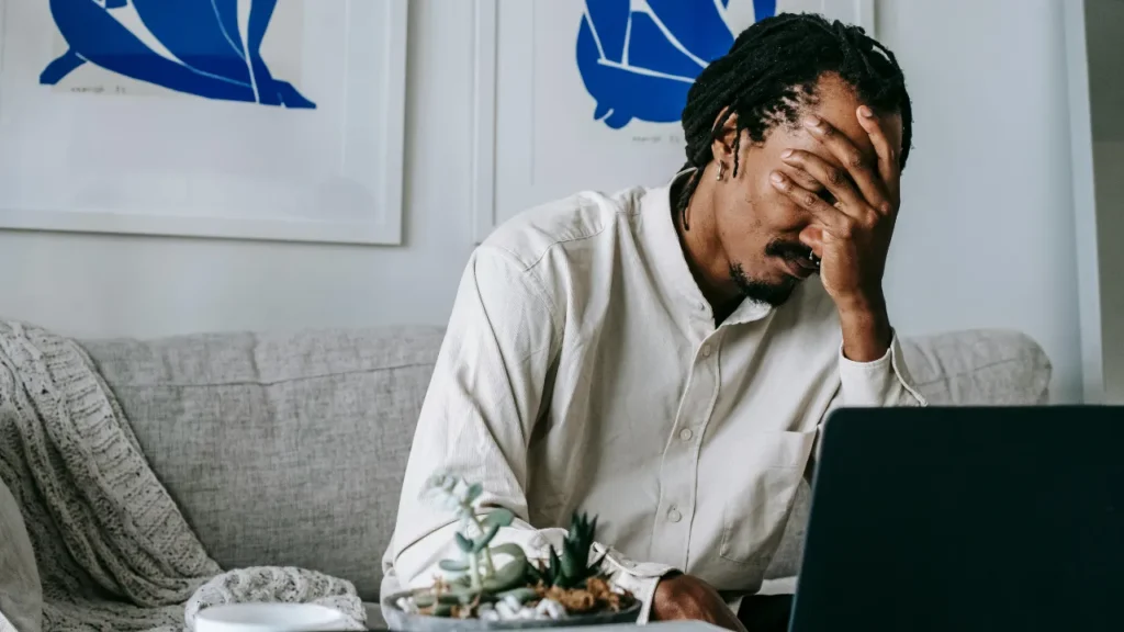 A stressed business professional overwhelmed by SEO decisions, demonstrating the importance of asking critical questions on how to hire SEO outsourcing services.