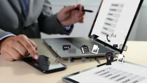A hand working on a laptop with business icons around "Choosing the best SEO outsourcing solution in 2025: Key questions to ask potential SEO companies for your business growth.